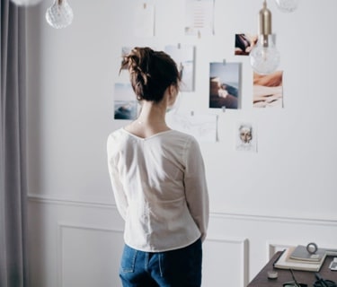 woman looking at pictures on the wall